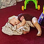 Robert is registered to the contest to win money with this photo: toddler, sleeping, blanket, carpet, toy, indoor, child, foot, hand, clothing, soft, cuddle, floor, playroom, colorful, peaceful, nap, person, comfort, relaxation