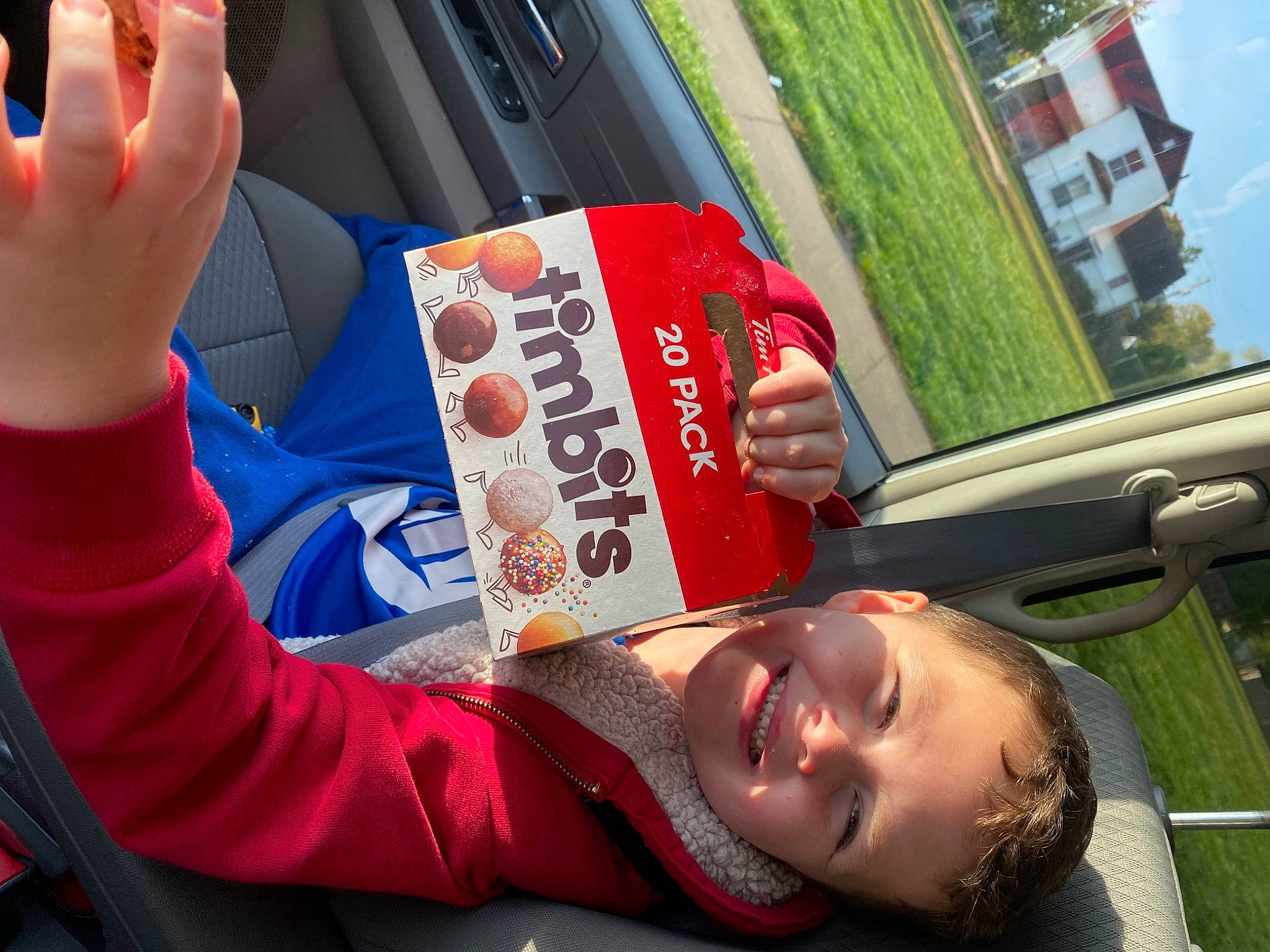 Andrew is registered to the contest to win money with this photo: automotive_design, automotive_exterior, automotive_lighting, car, child, drink, eyewear, family_car, finger, fun, gesture, happy, joy, leisure, motor_vehicle, person, plant, recreation, steering_wheel, travel