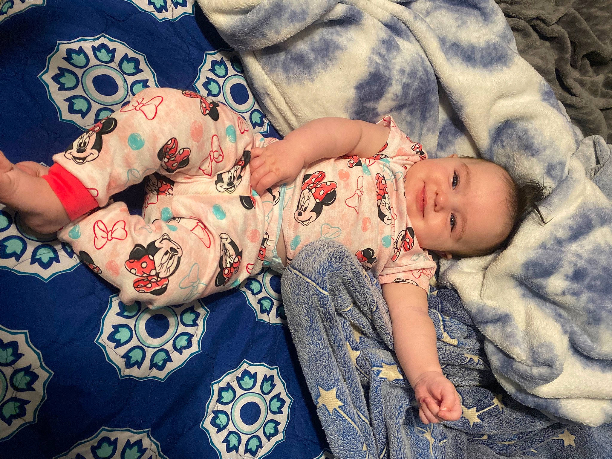 Avalynn is registered to the contest to win money with this photo: arm, baby, baby_sleeping, baby_toddler_clothing, bedding, child, cloud, comfort, happy, human_leg, infant_bodysuit, joy, linens, pattern, person, sitting, skin, sleeve, t_shirt, textile