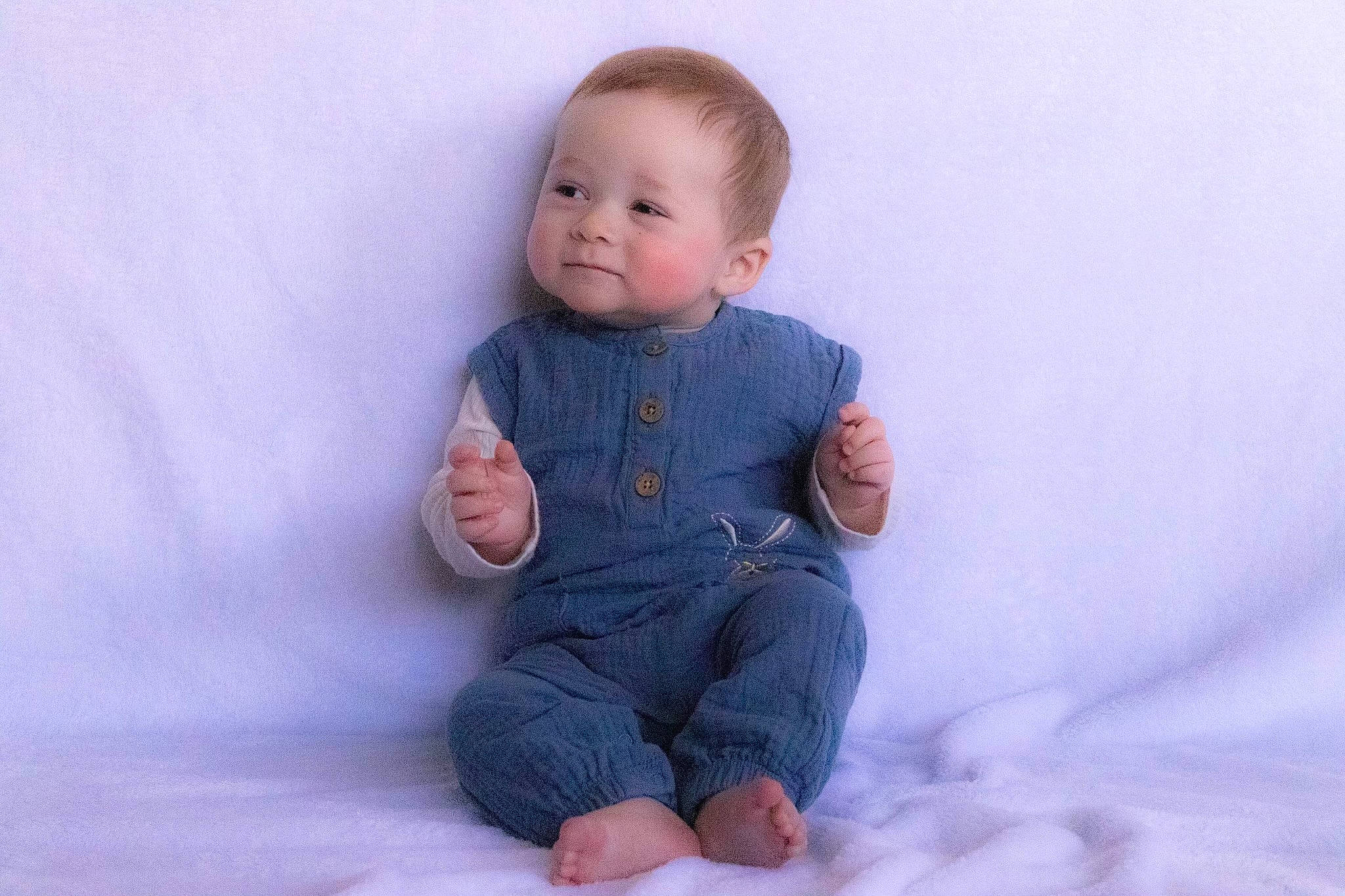 Lucius is registered to the contest to win money with this photo: arm, baby, baby_toddler_clothing, cheek, child, chin, collar, doll, dress_shirt, eye, finger, flooring, gesture, human_body, iris, leg, nose, outerwear, person, sleeve