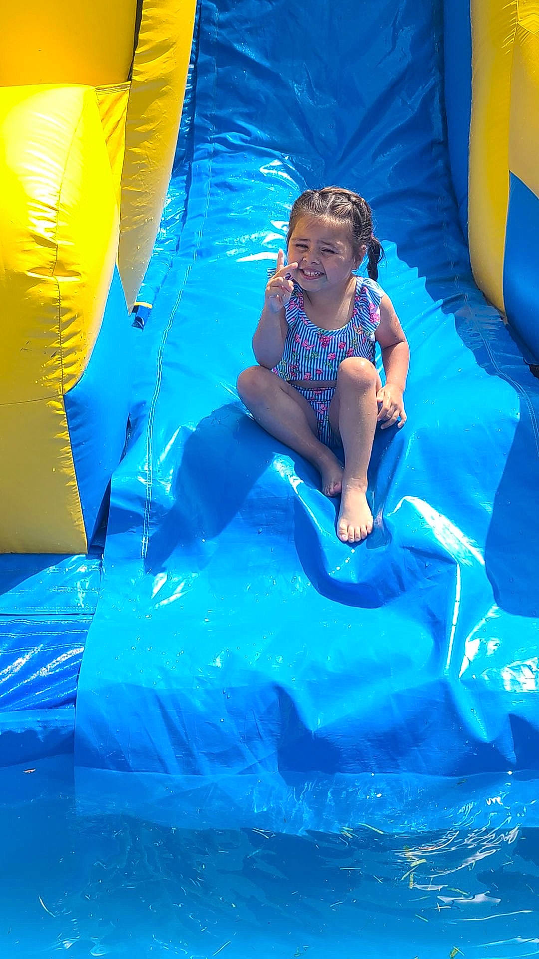 Armani joined the competition — help win amazing prizes! aqua, blue, chute, comfort, electric_blue, fun, games, grass, happy, inflatable, joy, leisure, outdoor_play_equipment, outdoor_recreation, person, play, recreation, sitting, smile, tarpaulin