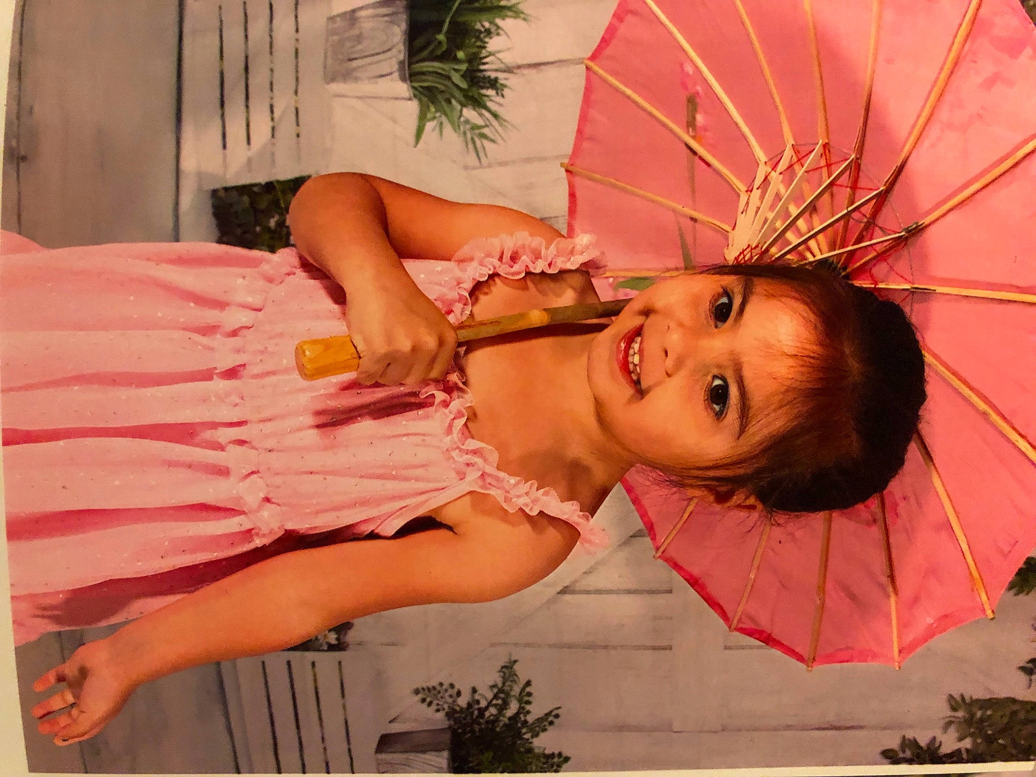 Armani is registered to the contest to win money with this photo: child, dress, eye, eyelash, fashion_accessory, fun, grass, happy, headpiece, human_body, joy, lip, magenta, orange, peach, person, pink, plant, skin, smile