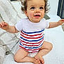 baby, bright_eyes, child, couch, cozy, curly_hair, cushion, cute, happy, home, indoor, infant, natural_light, onesie, portrait, sitting, small_feet, smiling, striped_clothing, white