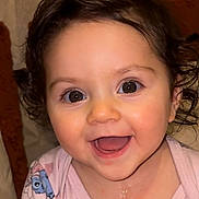 Kataleya participe au concours pour gagner de l'argent avec cette photo : baby, smiling, face, child, cute, pink_clothing, cartoon_print, curly_hair, happy, indoor, portrait, young_child, skin, big_eyes, mouth_open, cheeks, infant, joy, closeup, person