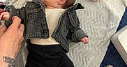 Aurora-Grace joined the competition — help win amazing prizes! baby, baby_care, black_pants, blanket, clothing, cute, denim_jacket, diaper, floor, foot, hand, head, indoor, infant, lying_down, person, plastic_bag, skin, soft_surface, tattoo