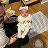 Aurora-Grace joined the competition — help win amazing prizes! baby, infant, child, person, adult, tattoo, glasses, white_clothing, pink_bow, pink_booties, wooden_floor, game_controller, bench, blanket, heart_pattern, indoor, floor, carpet, diaper_bin, casual