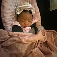 Akila is registered to the contest to win money with this photo: baby, bed, bedroom, blanket, bonnet, clothing, crib, cushion, face, furniture, hat, head, homedecor, infantbed, newborn, person, photography, portrait, quilt, sleeping