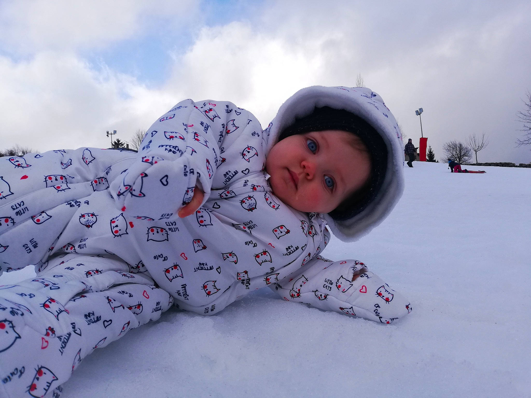 Mélina participe au concours pour gagner de l'argent avec cette photo : baby_toddler_clothing, child, cloud, comfort, face, freezing, fun, happy, headwear, landscape, outerwear, pattern, person, recreation, sitting, sky, sleeve, smile, snow, toddler