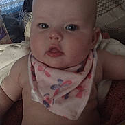 Leia joined the competition — help win amazing prizes! baby, infant, child, face, pink_bib, butterfly_pattern, close_up, curious_expression, indoor, blanket, soft_furnishing, cozy, cute, chubby, portrait, human, skin, head, eyes, mouth