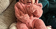 Persephone joined the competition — help win amazing prizes! baby, baby_face, blanket, child, couch, cozy, cushion, happy, home, hooded_outfit, indoor, infant, lying_down, photography, pink_outfit, plush_clothing, portrait, sitting, smiling, sofa