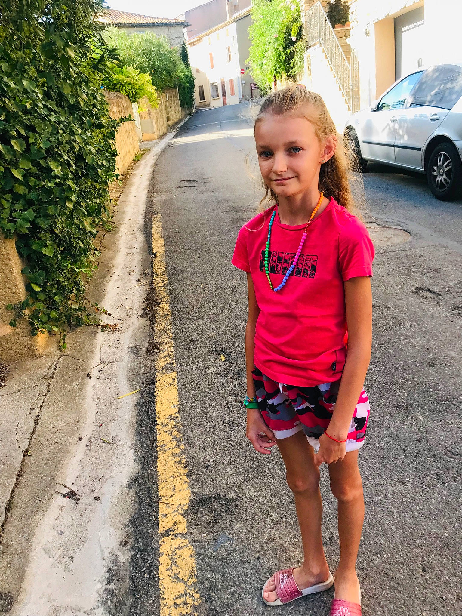 Rose participe au concours pour gagner de l'argent avec cette photo : asphalt, automotive_tire, car, grass, happy, joy, leisure, morning, person, plant, public_space, recreation, road, road_surface, shorts, sidewalk, smile, tire, toddler, travel