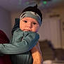 Ryder joined the competition — help win amazing prizes! baby, infant, child, face, headband, clothing, hand, person, portrait, indoors, adult_hand, cute, looking, cozy, soft_lighting, expression, skin, eyes, sleeve, holding