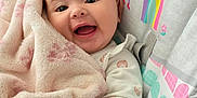 Geneva joined the competition — help win amazing prizes! baby, blanket, smiling, happy, infant, child, face, hand, plush, soft, rainbow, sun, seat, clothing, cute, comfort, portrait, indoors, person, baby_seat