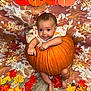 baby, pumpkin, autumn, fall, leaves, orange, child, smiling, festive, background, floor, decoration, cute, portrait, seasonal, holiday, indoors, clothing, barefoot, photography