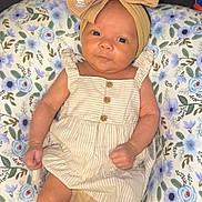 Kinlee joined the competition — help win amazing prizes! baby, infant, headband, bow, dress, striped, pillow, floral_pattern, couch, furniture, skin, legs, arms, face, eyes, mouth, hands, feet, indoors, portrait