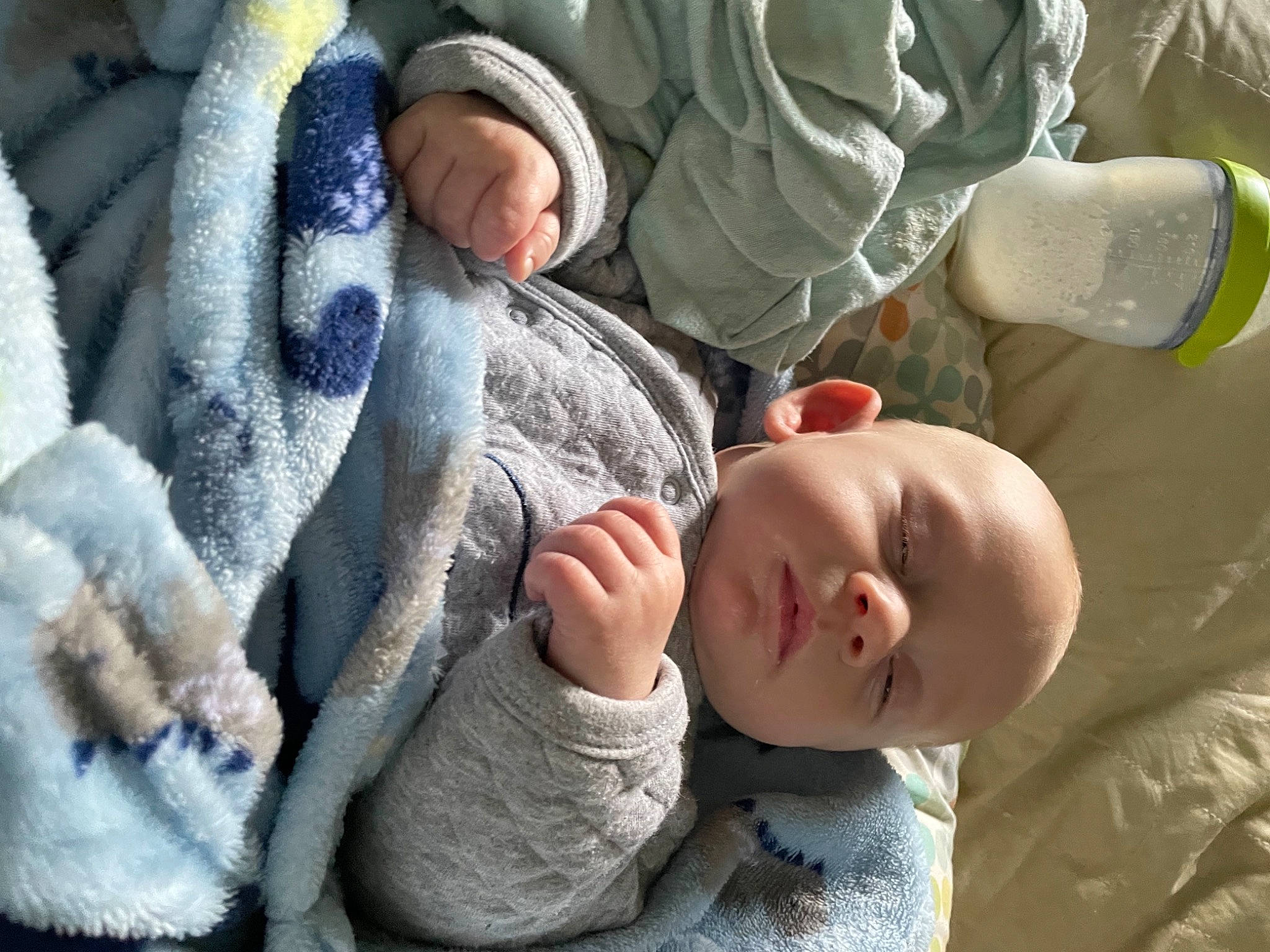 Dominik joined the competition — help win amazing prizes! baby, baby_toddler_clothing, child, comfort, facial_expression, gesture, grass, grey, hand, linens, mammal, military_camouflage, pattern, person, product, sitting, skin, toddler, tree, vertebrate