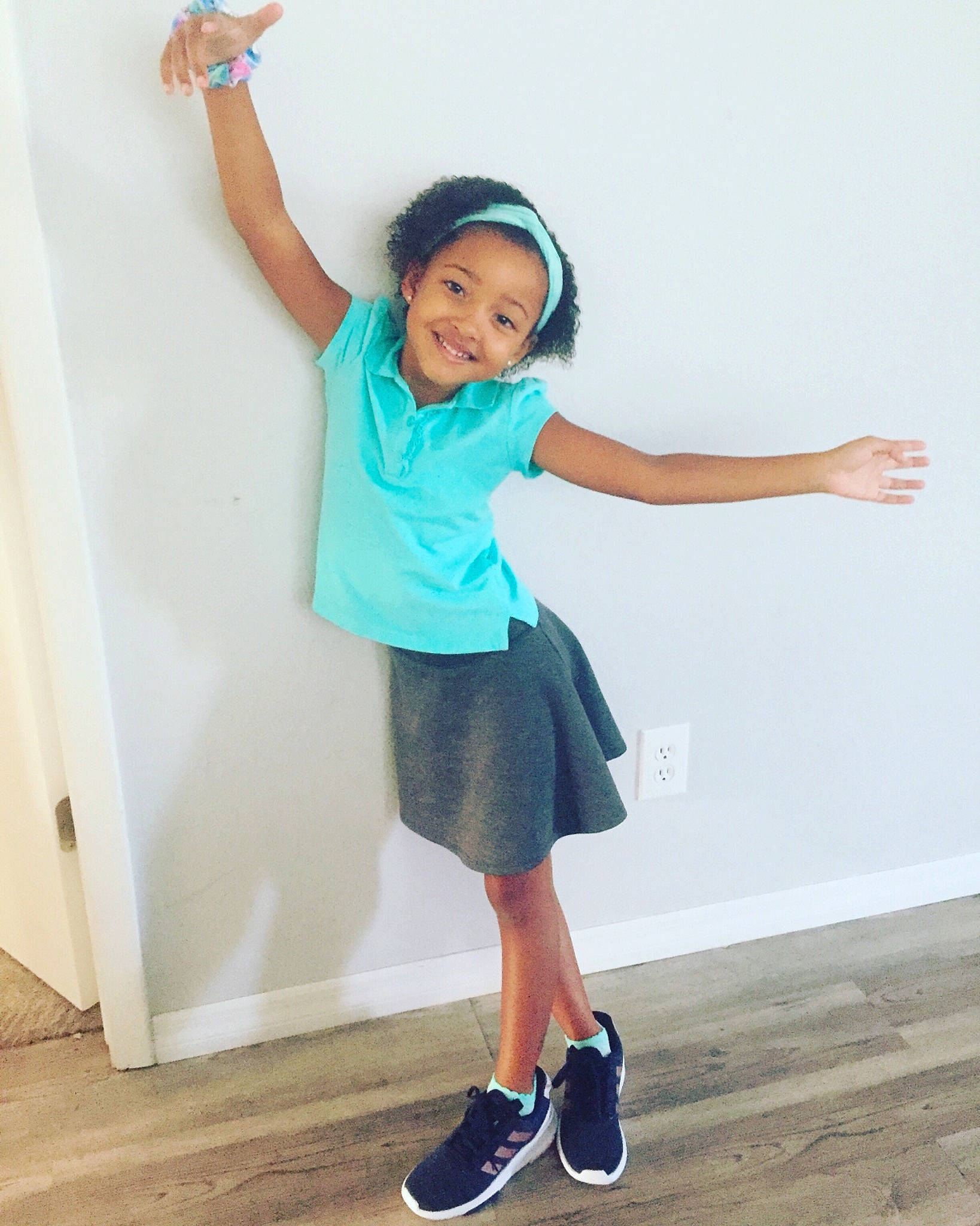 Abrielle is registered to the contest to win money with this photo: arm, balance, blue, child, footwear, fun, happy, human_body, human_leg, joint, joy, knee, leg, neck, person, shoe, shoulder, skin, standing, t_shirt