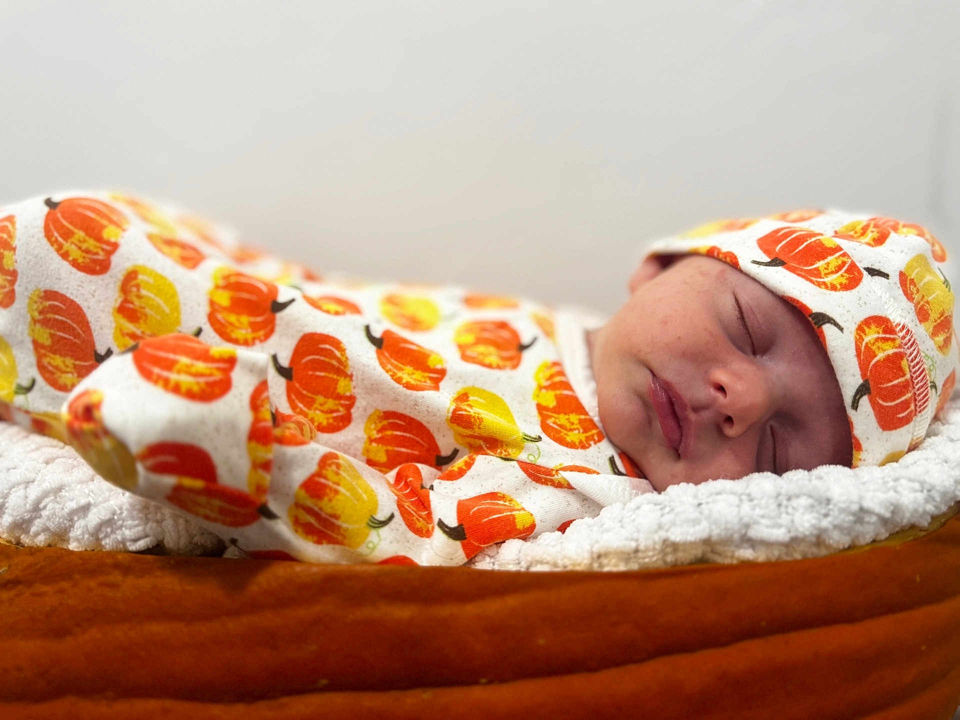 Rory joined the competition — help win amazing prizes! baby, sleeping, newborn, pumpkin_pattern, hat, blanket, soft_texture, cozy, infant, cute, face, closed_eyes, rest, warm_colors, autumn_theme, clothing, comfort, portrait, indoors, peaceful