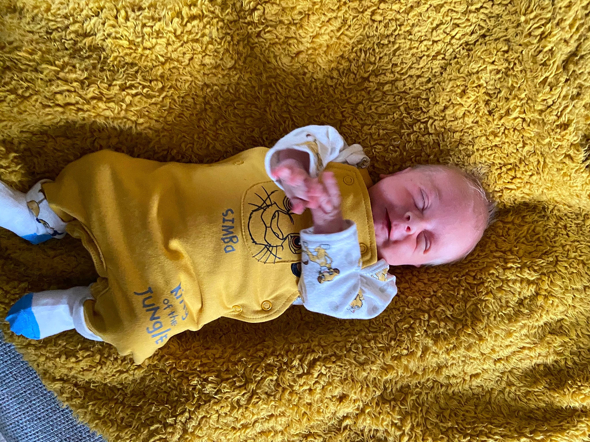 Cillian is registered to the contest to win money with this photo: baby, baby_toddler_clothing, child, comfort, eye, flooring, fun, grass, happy, hat, head, headgear, people_in_nature, person, sand, sitting, sleeve, smile, soil, toddler