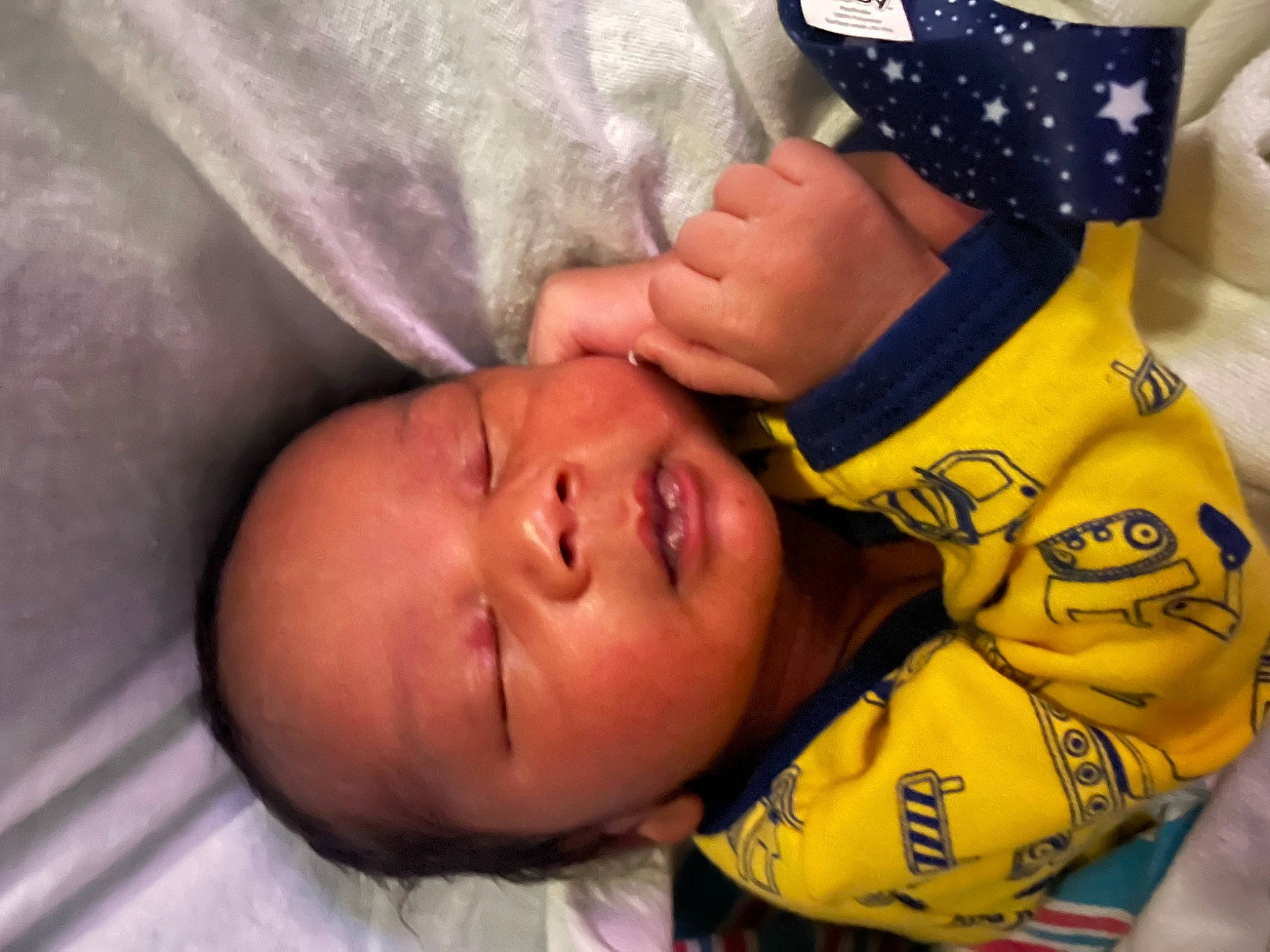 Kaison is registered to the contest to win money with this photo: baby, baby_products, cheek, chest, child, comfort, finger, fun, gesture, hand, headgear, human_body, nail, nose, person, personal_protective_equipment, sleeve, thumb, toddler, tree