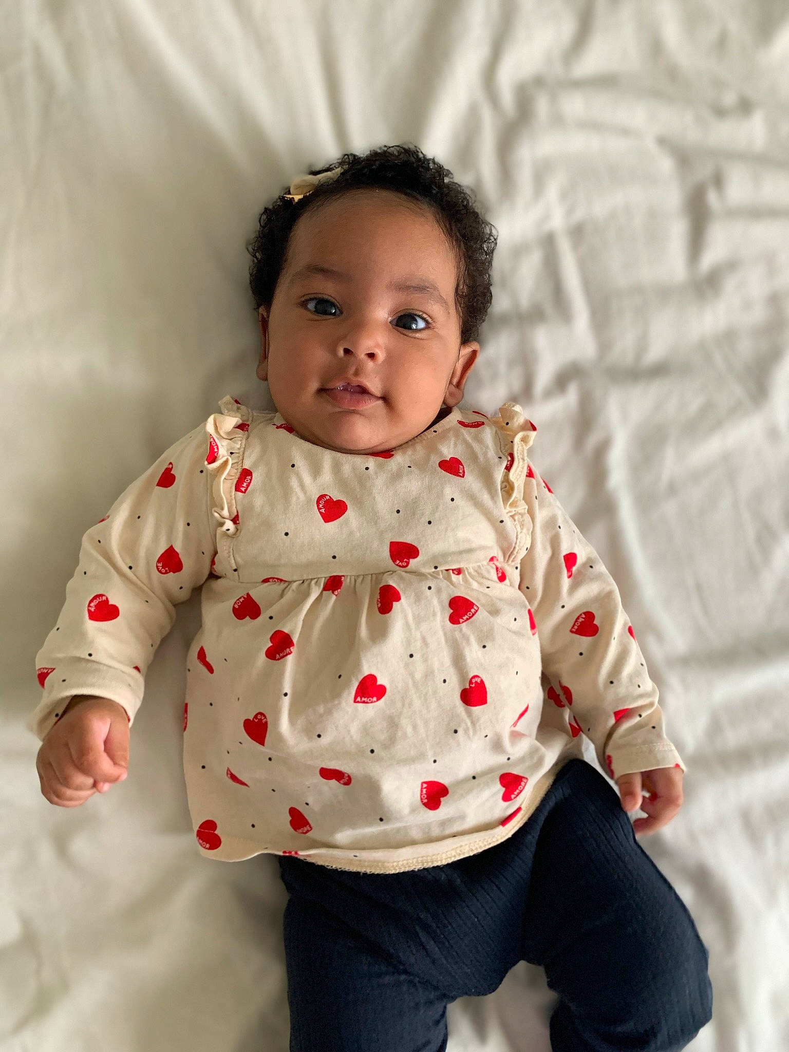 Tayanna participe au concours pour gagner de l'argent avec cette photo : baby, baby_toddler_clothing, cheek, child, clothing, collar, face, fun, happy, head, neck, nose, outerwear, pattern, person, play, skin, sleeve, textile, toddler