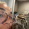 Leo Pickle joined the competition — help win amazing prizes! person, cat, glasses, nose_ring, close_up, indoor, tabby_cat, face, fur, whiskers, curious, affection, home, cabinet, lighting, eyewear, portrait, skin, hair, expression
