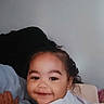 Miah'Ja joined the competition — help win amazing prizes! baby, bed, blanket, candid, child, cozy, curly_hair, face, happy, head, indoor, infant, person, pillow, portrait, resting, skin, smile, toddler, young_child