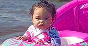 Miah'Ja joined the competition — help win amazing prizes! baby, blue, child, curly_hair, floating, hand, inflatable_ring, lake, nature, outdoor, pink, play, recreation, serious_face, summer, sunlight, swimwear, toddler, trees, water
