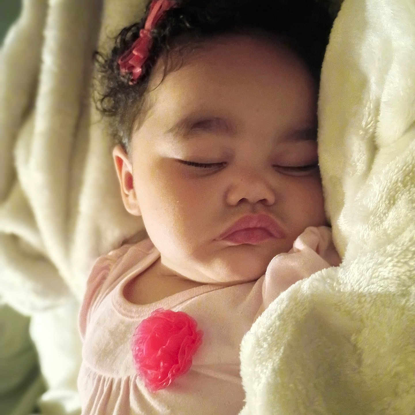 Miah'Ja is registered to the contest to win money with this photo: baby, sleeping, blanket, curly_hair, pink_bow, face, child, soft, cozy, infant, closeup, resting, peaceful, cute, indoors, portrait, apparel, flesh_tone, head, toddler