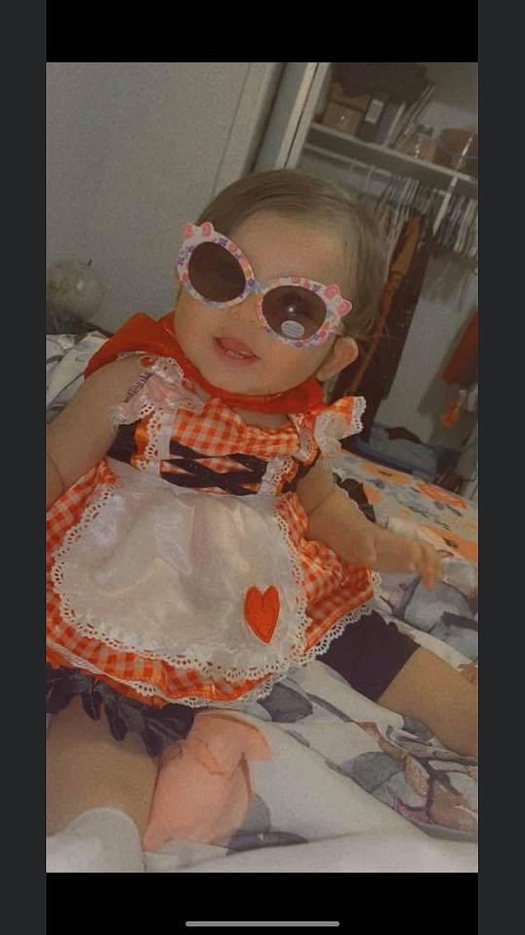 Everleigh is registered to the contest to win money with this photo: baby_toddler_clothing, cheek, day_dress, doll, dress, embellishment, eyewear, fashion_design, fawn, glasses, goggles, lip, one_piece_garment, pattern, person, pink, sleeve, sunglasses, toy, vision_care