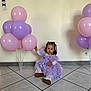 toddler, child, balloons, lavender_dress, purple, pink, floor_tiles, indoor, curly_hair, white_shoes, long_sleeve_shirt, party, celebration, young_child, sitting, decor, walls, cute, portrait, curious