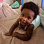 Lalyah participe au concours pour gagner de l'argent avec cette photo : baby, child, smiling, blanket, indoor, cute, lying_down, curly_hair, infant, cozy, soft_texture, happy, person, portrait, skin, arm, face, clothing, baby_girl, baby_boy