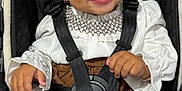 Bella joined the competition — help win amazing prizes! baby, child, smiling, curly_hair, bow, stroller, seatbelt, white_clothing, brown_clothing, knit_socks, happy, cute, infant, portrait, indoors, person, baby_girl, fashion, accessory, comfort