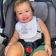 Nathan joined the competition — help win amazing prizes! toddler, child, car_seat, smile, happy, baby, bib, clothing, sitting, seatbelt, green_shorts, face, person, infant, cute, indoors, safety_harness, young_child, portrait, joyful