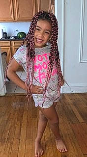 Melody is registered to the contest to win money with this photo: black_hair, braid, cornrows, dreadlocks, face, fashion_design, flooring, fun, hair_accessory, happy, hardwood, joy, laminate_flooring, long_hair, neck, pattern, person, sleeve, smile, wood