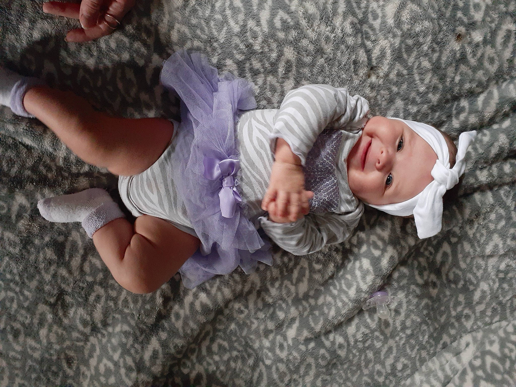 October is registered to the contest to win money with this photo: baby_toddler_clothing, comfort, dress, eye, finger, gesture, glasses, grass, hand, happy, head, headwear, leg, person, pink, plant, skin, smile, thigh, toddler