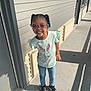 Tiara is registered to the contest to win money with this photo: child, city, clothing, door, face, female, footwear, girl, head, jeans, pants, person, photography, portrait, road, shoe, sleeve, standing, street, t_shirt