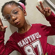 Tiara joined the competition — help win amazing prizes! child, girl, glasses, red_shirt, peace_sign, butterfly_patch, hair_accessory, pink, earrings, portrait, casual, indoor, cute, playful, smiling, fashion, person, young, happy, wall