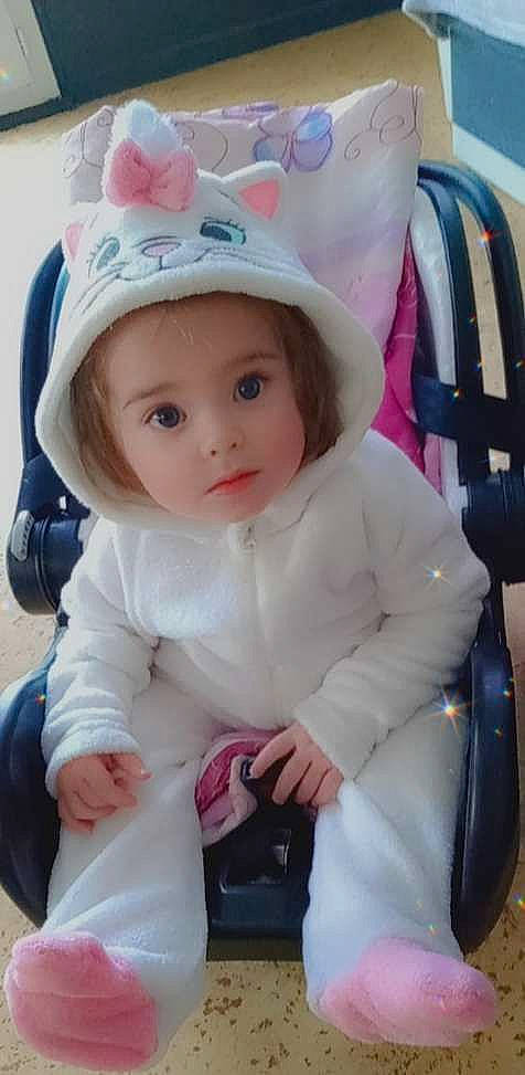 Innaya a rejoint le concours — aidez-le/la à gagner de superbes lots ! baby, baby_products, baby_safety, baby_toddler_clothing, cap, cheek, child, comfort, costume_hat, fashion_accessory, happy, hat, headgear, magenta, person, pink, portrait_photography, sitting, sleeve, toddler