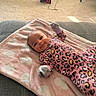 Skyla joined the competition — help win amazing prizes! baby, infant, smiling, pink_blanket, leopard_print, onesie, mittens, couch, carpet, heater, framed_photos, living_room, cozy, soft_texture, happy, portrait, indoor, child, cute, comfortable