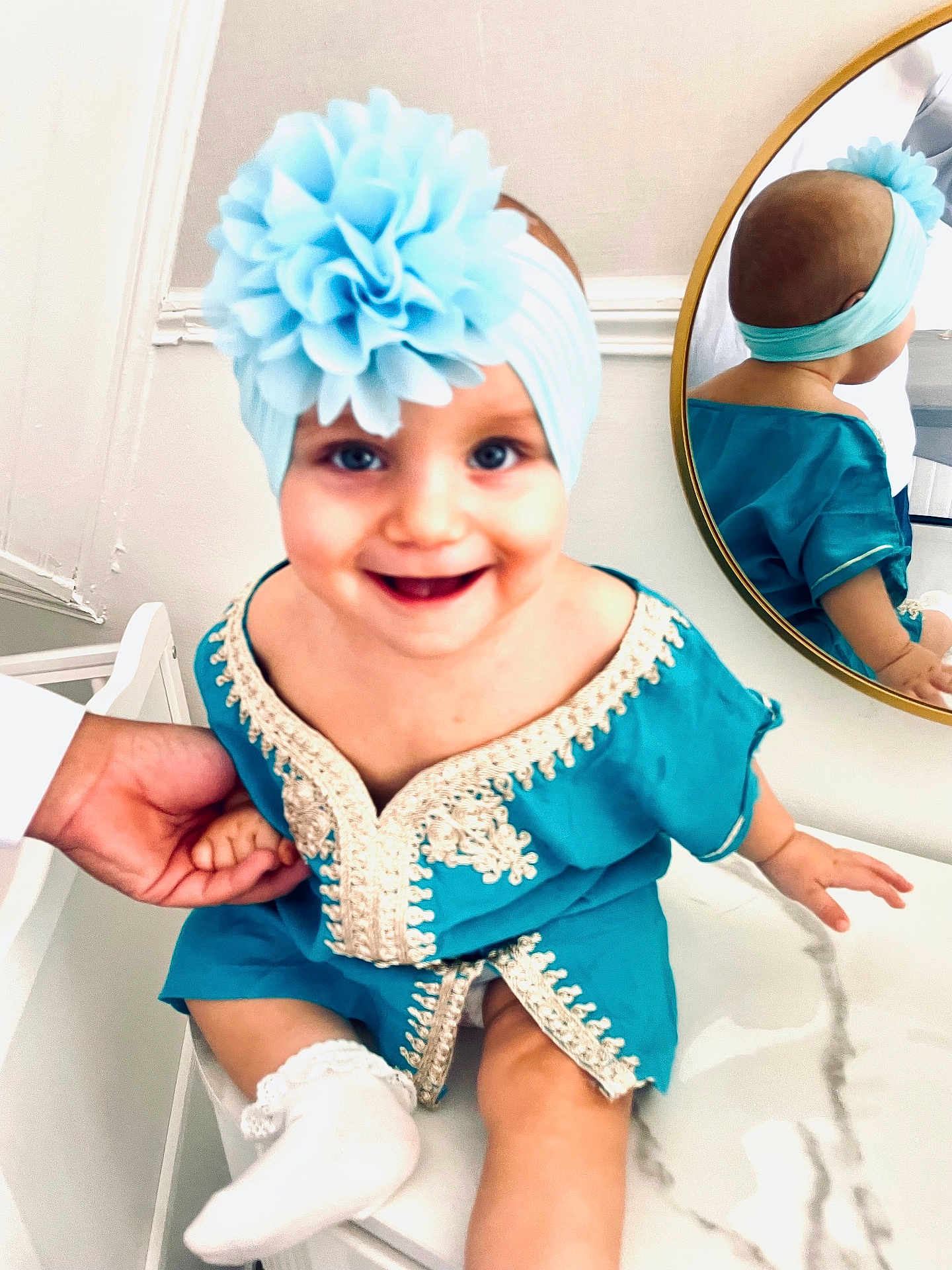 Ova participe au concours pour gagner de l'argent avec cette photo : baby, child, smile, headband, flower, mirror, reflection, marble, hand, turquoise, blue, white, sock, clothing, embroidery, indoor, person, cute, happy, sitting