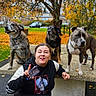  하ppy, adult, autumn, bench, black_dog, brown_dog, collar, dog, fallen_leaves, grass, outdoor, park, person, portrait, seated, standing, street, three_dogs, tree, urban