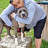 affection, american_bully, building, dog, fence, garden, grass, hoodie, hugging, man, outdoor, owner, pet, portrait, scooter, sitting, sneakers, standing, stone, sunglasses