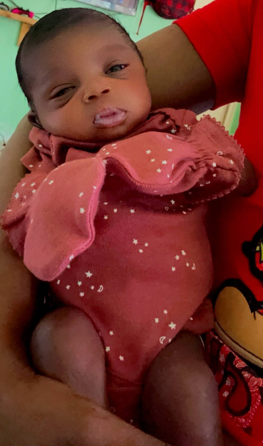 Layla is registered to the contest to win money with this photo: baby, blanket, bodypart, clothing, couch, cushion, face, finger, furniture, hand, happy, head, homedecor, indoors, newborn, person, photography, portrait, smile, t_shirt