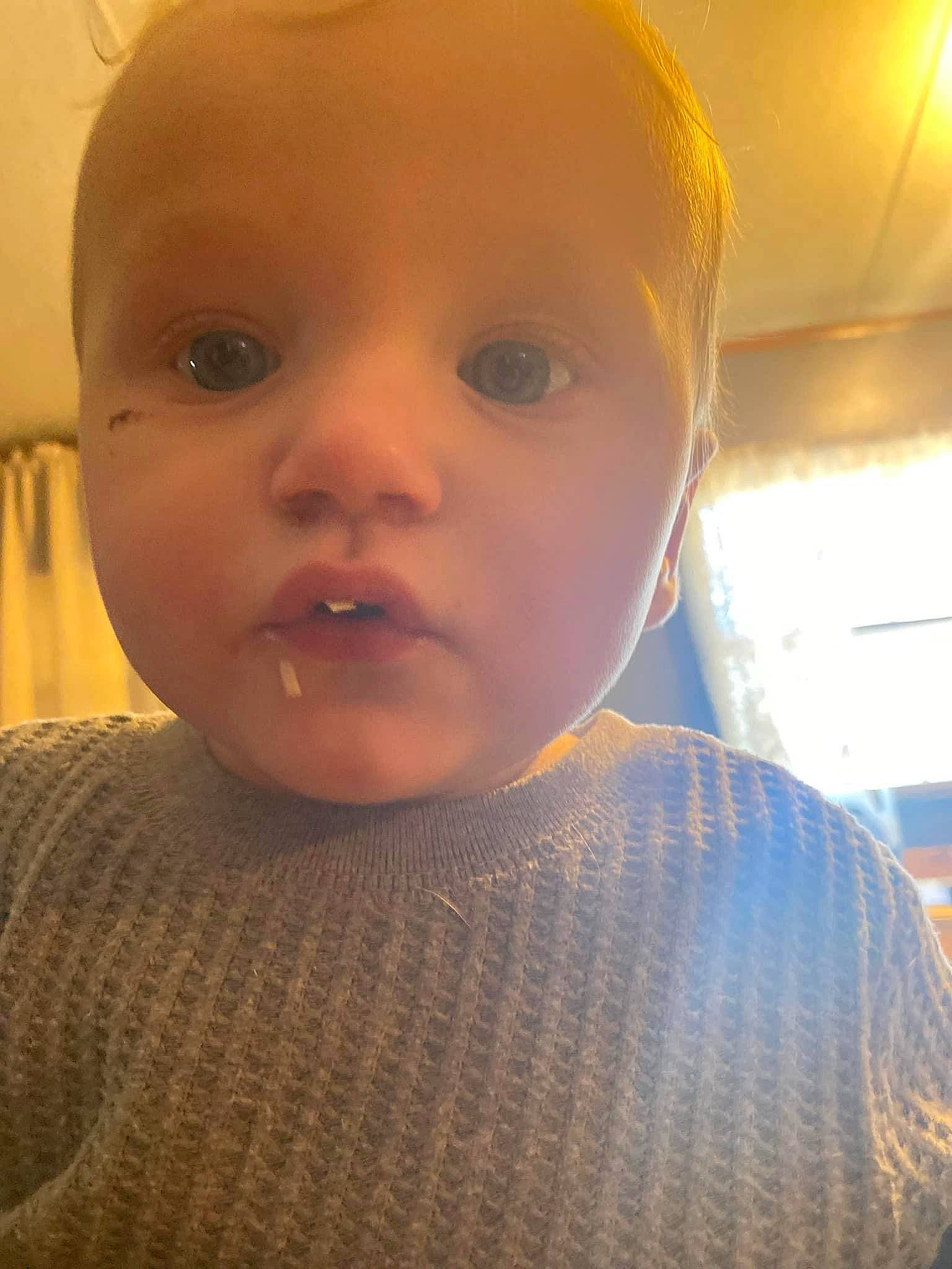 Desmond is registered to the contest to win money with this photo: baby, baby_toddler_clothing, cheek, child, ear, eyebrow, eyelash, forehead, happy, iris, lip, nose, person, skin, toddler, wool, woolen, woven_fabric