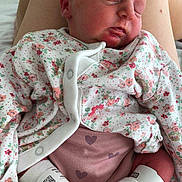 Carolynà is registered to the contest to win money with this photo: baby, bed, cozy, cute, feet, floral_clothing, hospital_band, human, indoors, infant, legs, newborn, peaceful, person, pink_pants, portrait, resting, skin, sleeping, toddler