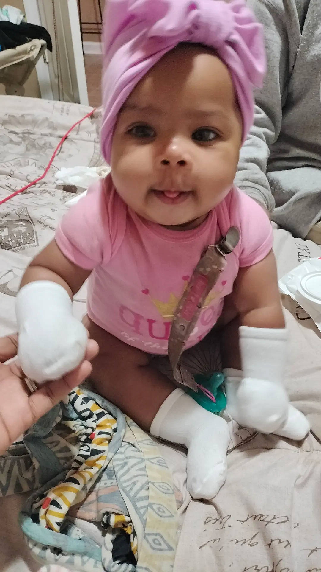 De'Janae is registered to the contest to win money with this photo: baby, baby_toddler_clothing, cap, cheek, child, event, eye, face, fashion_accessory, finger, happy, headwear, mouth, person, pink, product, purple, skin, sleeve, smile