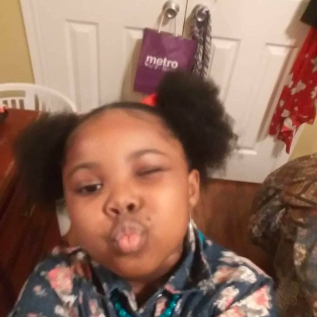 De'Asia is registered to the contest to win money with this photo: black_hair, cheek, child, chin, cool, ear, eyebrow, eyelash, forehead, fun, hair_care, hair_coloring, hairstyle, happy, jaw, long_hair, military_camouflage, nose, person, room