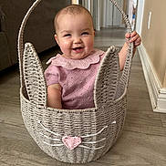 Adley joined the competition — help win amazing prizes! baby, basket, bunny, child, cute, floor, happy, home, indoors, person, pink_clothing, plush, smile, wicker, wood_floor, whiskers, ears, handle, cuteness, playful