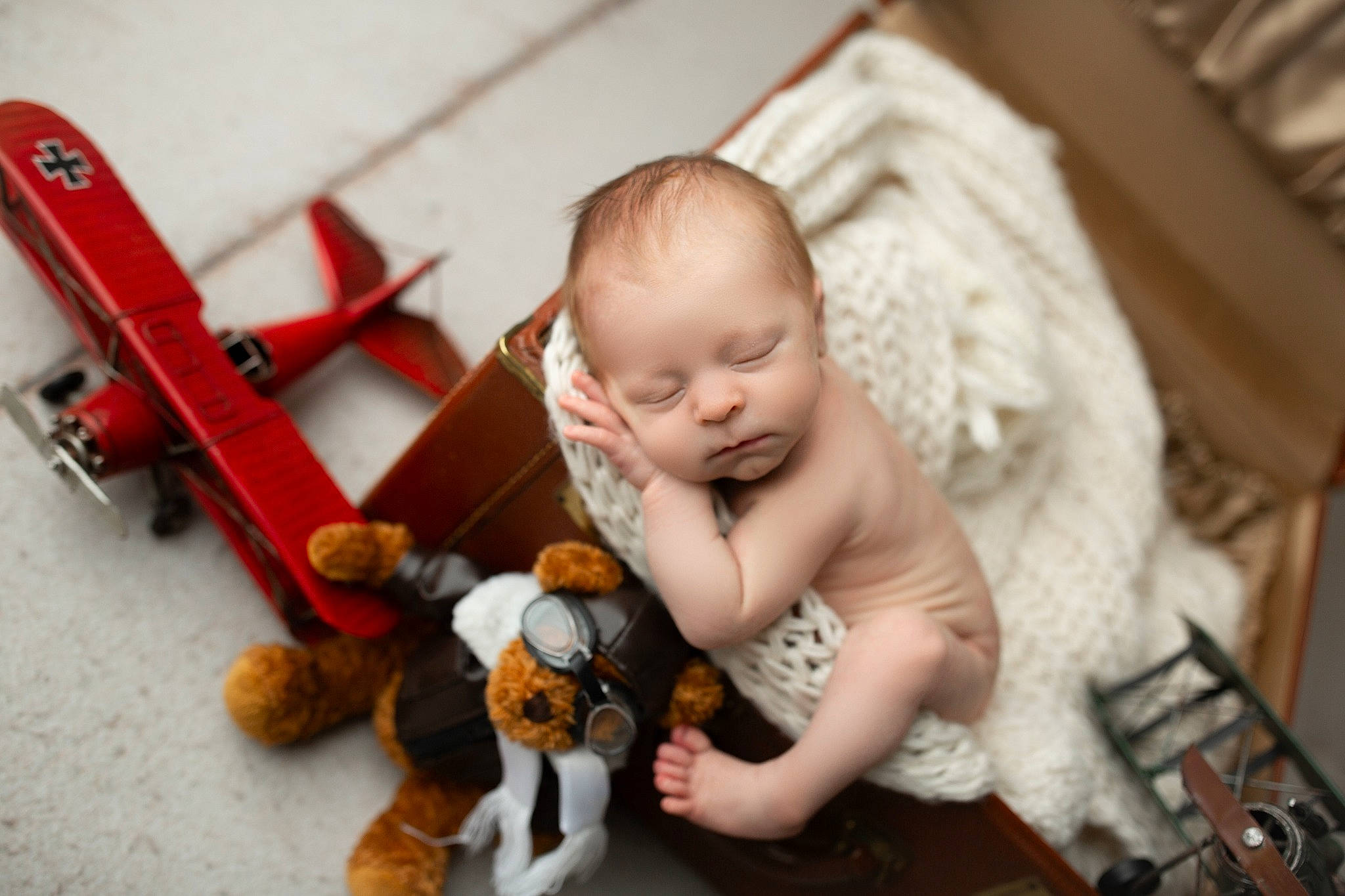 Judson is registered to the contest to win money with this photo: aircraft, airplane, baby, baby_products, baby_toys, child, doll, figurine, flooring, person, propeller, propeller_driven_aircraft, room, sitting, stuffed_toy, teddy_bear, toddler, toy, toy_airplane, toy_vehicle